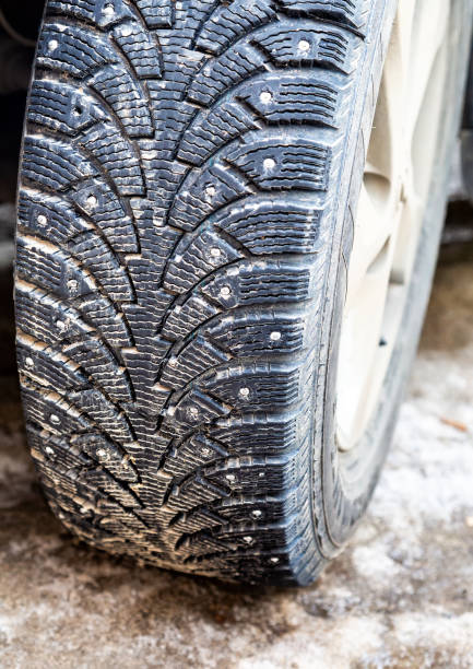 istock Used winter studded car wheel 1140207759