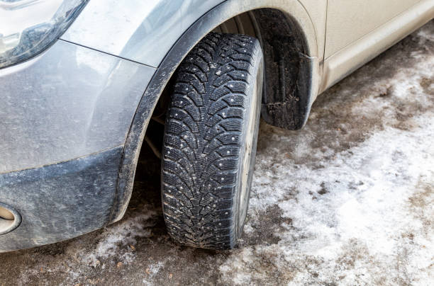 istock Used winter studded car wheel 1140207760