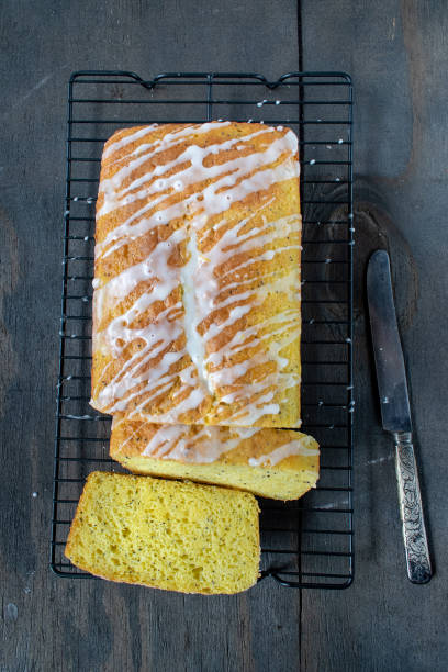 istock baked lemon poppy seed cake loaf with white icing drizzle 1140207799