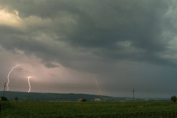 istock Evening thunderstorm with several lightning bolts striking down to earth 1140209707