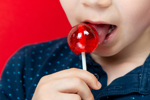 Little Boy Eating Red Lollipop