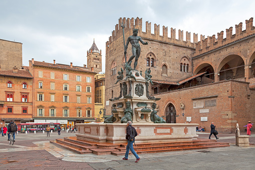 Bologna, Italy - April 02 2019: The Fountain of Neptune (Italian: Fontana di Nettuno) is a monumental civic fountain located in the eponymous square, Piazza del Nettuno, next to Piazza Maggiore.