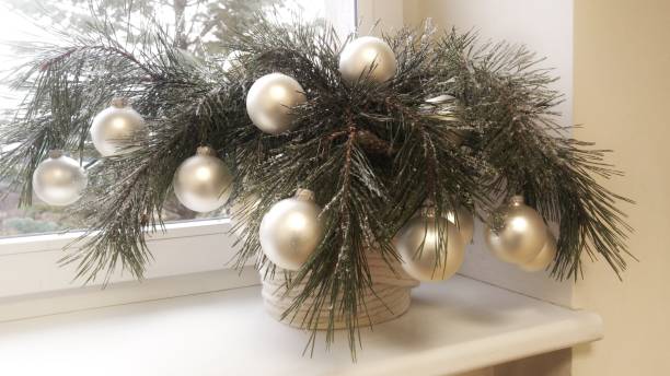 istock Pine tree branch decorated on the windowsill. 1140212526