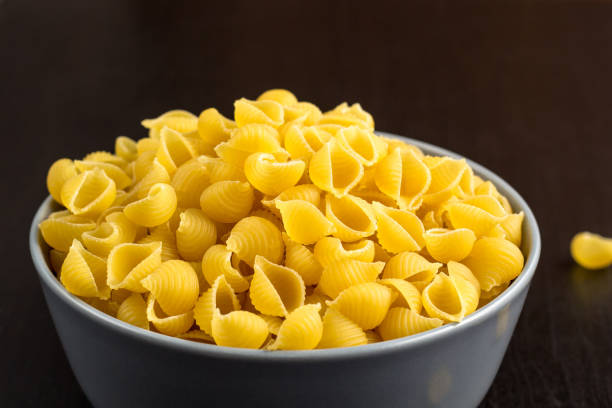 istock black background with italian raw conchiglie paste shells in bowl with copy space 1140213342