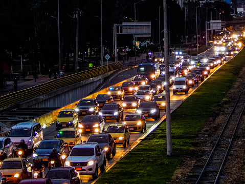 Traffic jam in an avenue with cars and railroad aside in Bogota Colombia