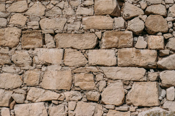 istock Old stone wall texture, blocks of ancient castle surface as background for design 1140214060