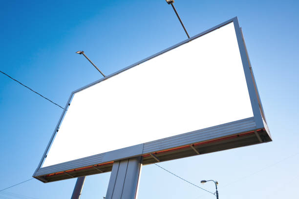 istock 3x6 billboard standing against the sky during the daytime, with a white advertising space mockup 1140215250