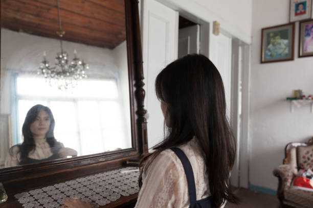istock Beautiful Woman looking mirror 1140216923