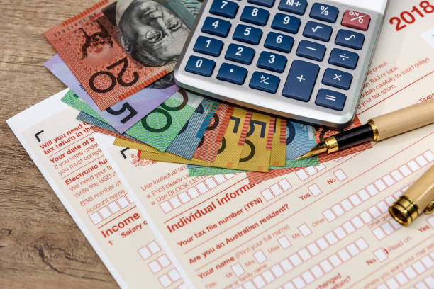 istock Australian dollars with calculator and tax form 1140216996