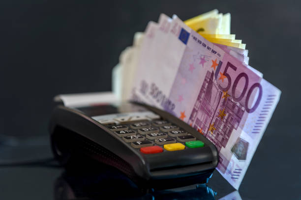 istock Euro banknotes with terminal on black background 1140218003