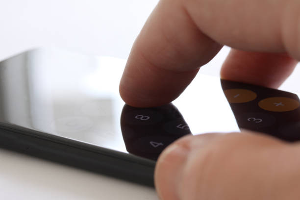 istock Smartphone with fingers touching the screen and keybord in background. Selective focus and extreme close up and hard contrast fading out for copy writing 1140218164