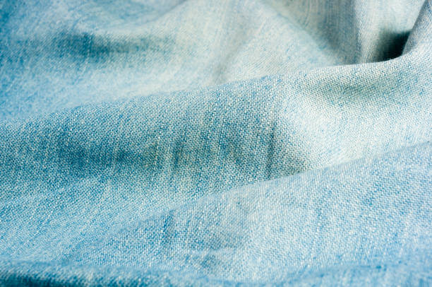 istock Blue washed faded jeans texture with seams 1140221070