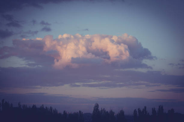 Landscape with dramatic light - beautiful golden sunset with saturated sky and clouds, peaceful nature serene background.
