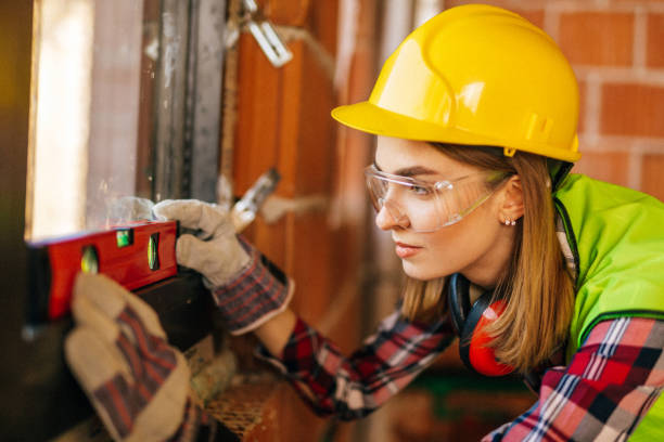 istock Blue-collar woman working on the construction site 1140221290