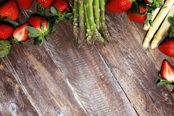 istock White and green asparagus with strawberries on wood 1140222459