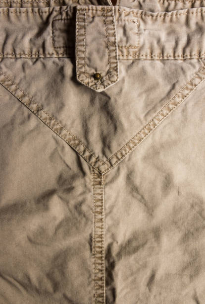 istock clothing items washed cotton fabric texture with seams, clasps, buttons and rivets 1140224176