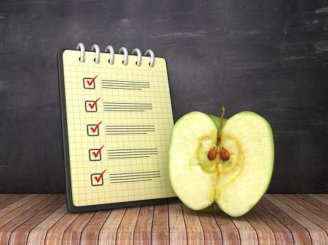 Check List Note Pad with Apple on Chalkboard Background  - 3D Rendering