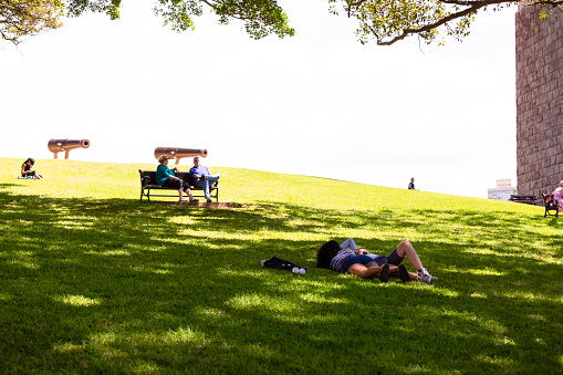 Sydney, Australia -March 03, 2019: People relaxing on lawn of First Fleet Park at Circular Quay Sydney on sunny day