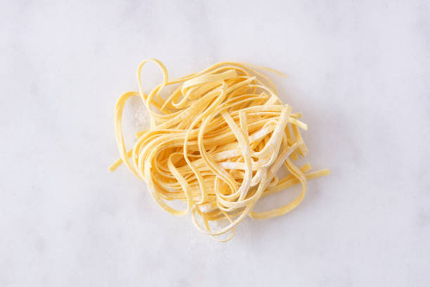 färsk linguine pasta, topputsikt mot vit marmor - foton med kanada bildbanksfoton och bilder