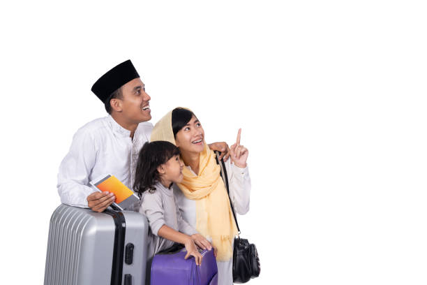 muslim family with suitcase looking up muslim family with suitcase looking up to copyspace. ready for ramadan holiday hari raya family stock pictures, royalty-free photos & images