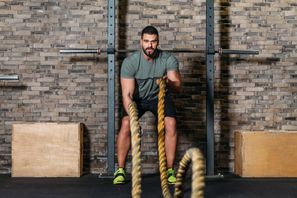istock Athlete workout with battle rope at gym 1140242703