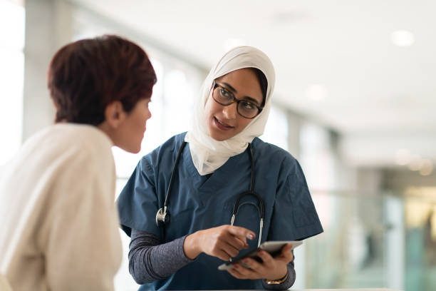 istock Muslim female doctor talking with her patient 1140250426