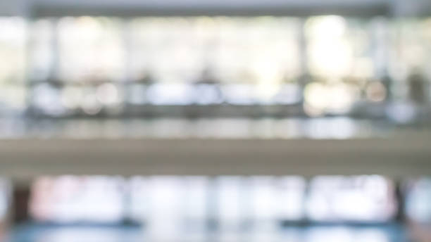istock Business office corridor blur background interior view empty lobby hallway with glass wall white room and light bokeh 1140252034