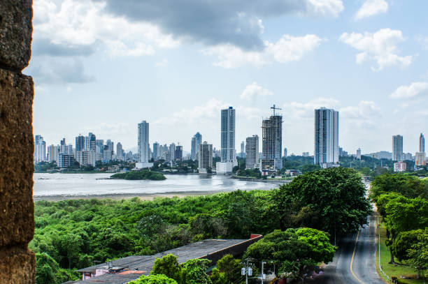 View from Old Panama archeological ruins, part of the ruins wall at the left hand and at the foreground the green trees frame the modern Panama City skyline, December 30, 2009