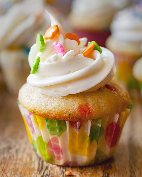 istock Close up view of a mini cupcake decorated with spring and Easter decorations.  Additional cupcakes blurred in the background. 1140273084