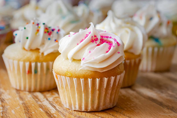 istock Mini cupcakes decorated with spring and Easter candy sprinkles.  Additional cupcakes blurred in the background. 1140273145