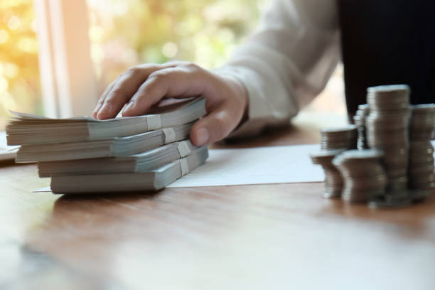 istock Businessman analyzing investment charts and pressing calculator buttons over documents. Accounting Concept  Saving Economy concept. 1140276776