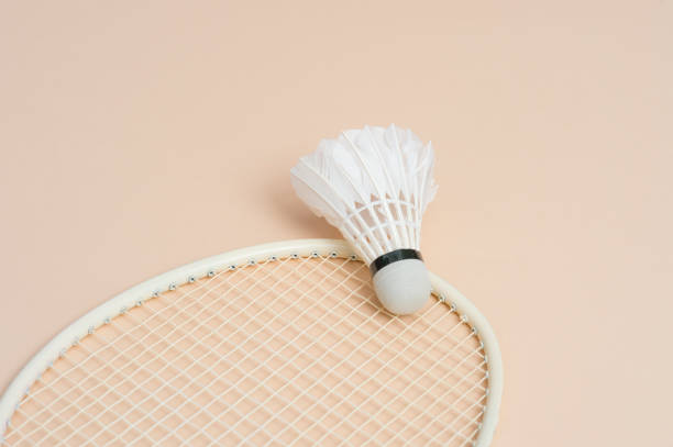 istock Shuttlecock and racket for playing badminton on a cream background. 1140277481