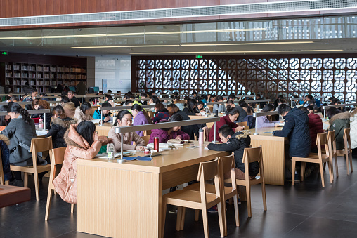 Chengdu, Sichuan province, China - Jan 21, 2016 : People reading in the interior of the Chengdu public library which is located in the center of the city.