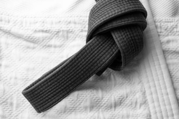istock Black judo, aikido or karate belt on white kimono 1140281979