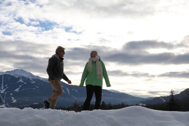 istock Mature couple walk through deep snow 1140288539