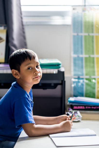 istock Child boy is writing a book in the room. 1140288879