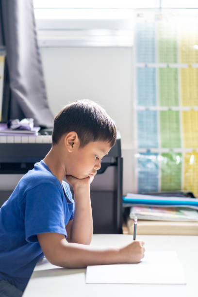 istock Child boy is writing a book in the room. 1140288880