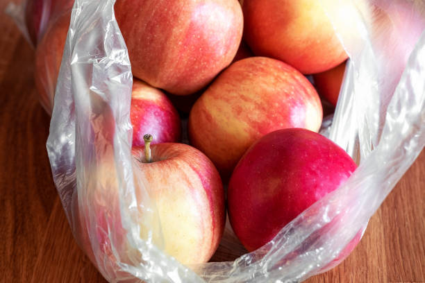 istock Apple fruit in plastic bag on wood table 1140290095