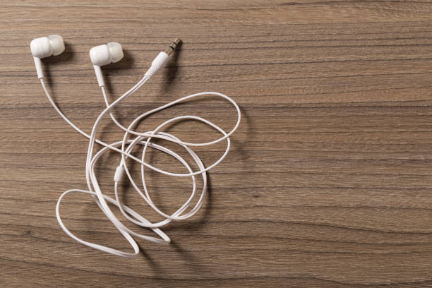 istock headphones and on rustic wooden table. Top view 1140293446