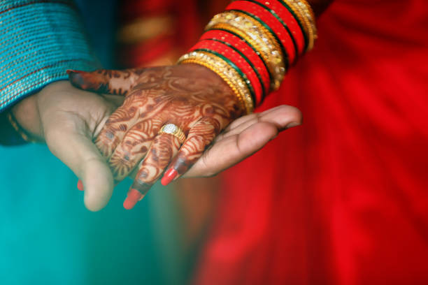 istock Golden engagement ring in bride and groom hand 1140294829