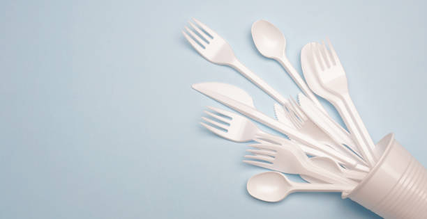 istock Single-use plastic products: plastic cutlery, cups on bright blue background 1140295086
