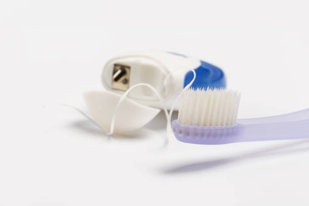 istock Dental floss and toothbrush on a white background. 1140295337