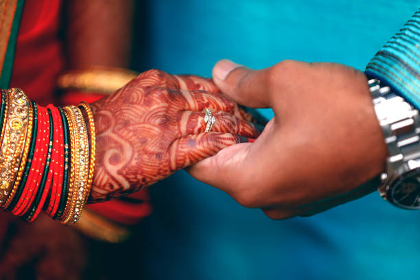 istock Golden engagement ring in bride and groom hand 1140296063
