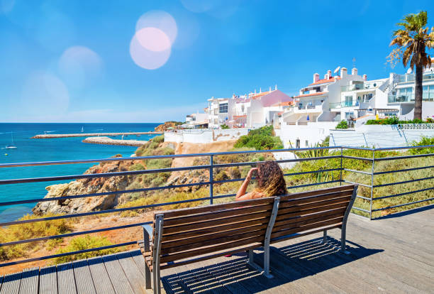 istock pretty woman sitting by the ocean 1140297427