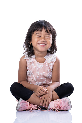 smiling toddler to camera. expressive asian young kid isolated over white background