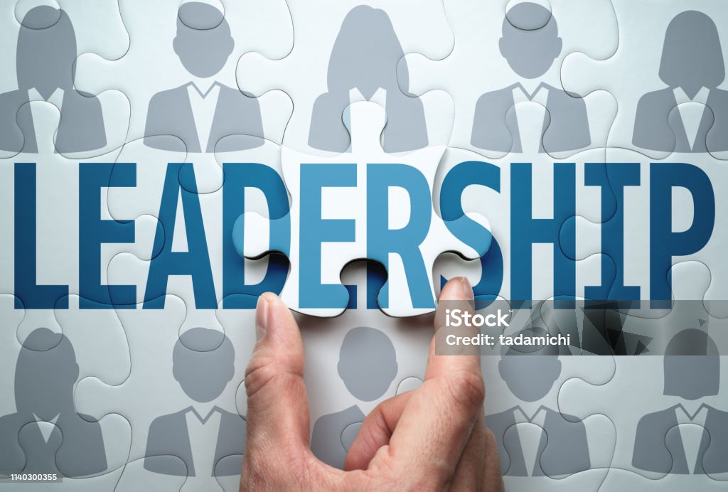 Business leadership concept. Building team and effecting solution. Connecting last jigsaw puzzle piece. Leadership Stock Photo
