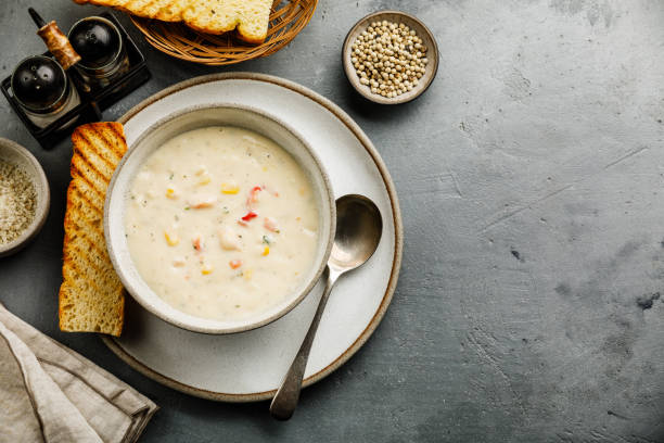 Chowder Crab Soup with shrimps and corn on concrete background copy space