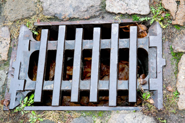 istock Street drainage sewer system with metal grid cover 1140303082