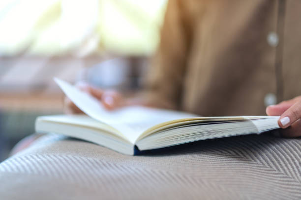 istock a woman opening and reading a book 1140303230