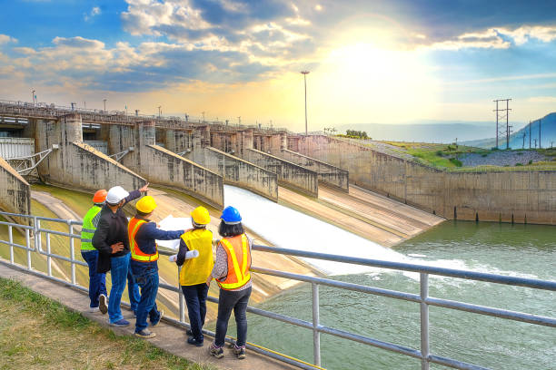 The success of the engineering team together to develop water power in the dam to generate electricity. stock photo